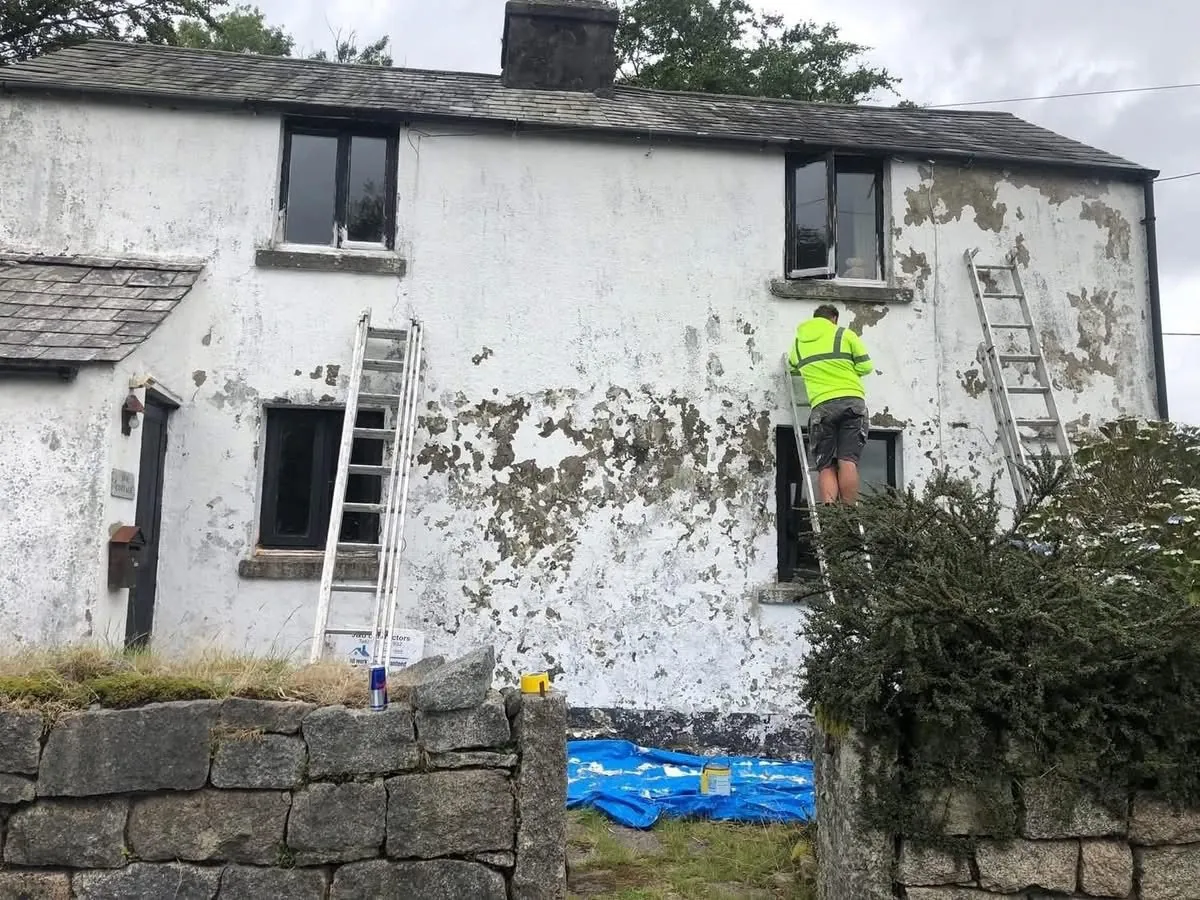 Cottage with blown, flaking render before repair in Sidmouth
